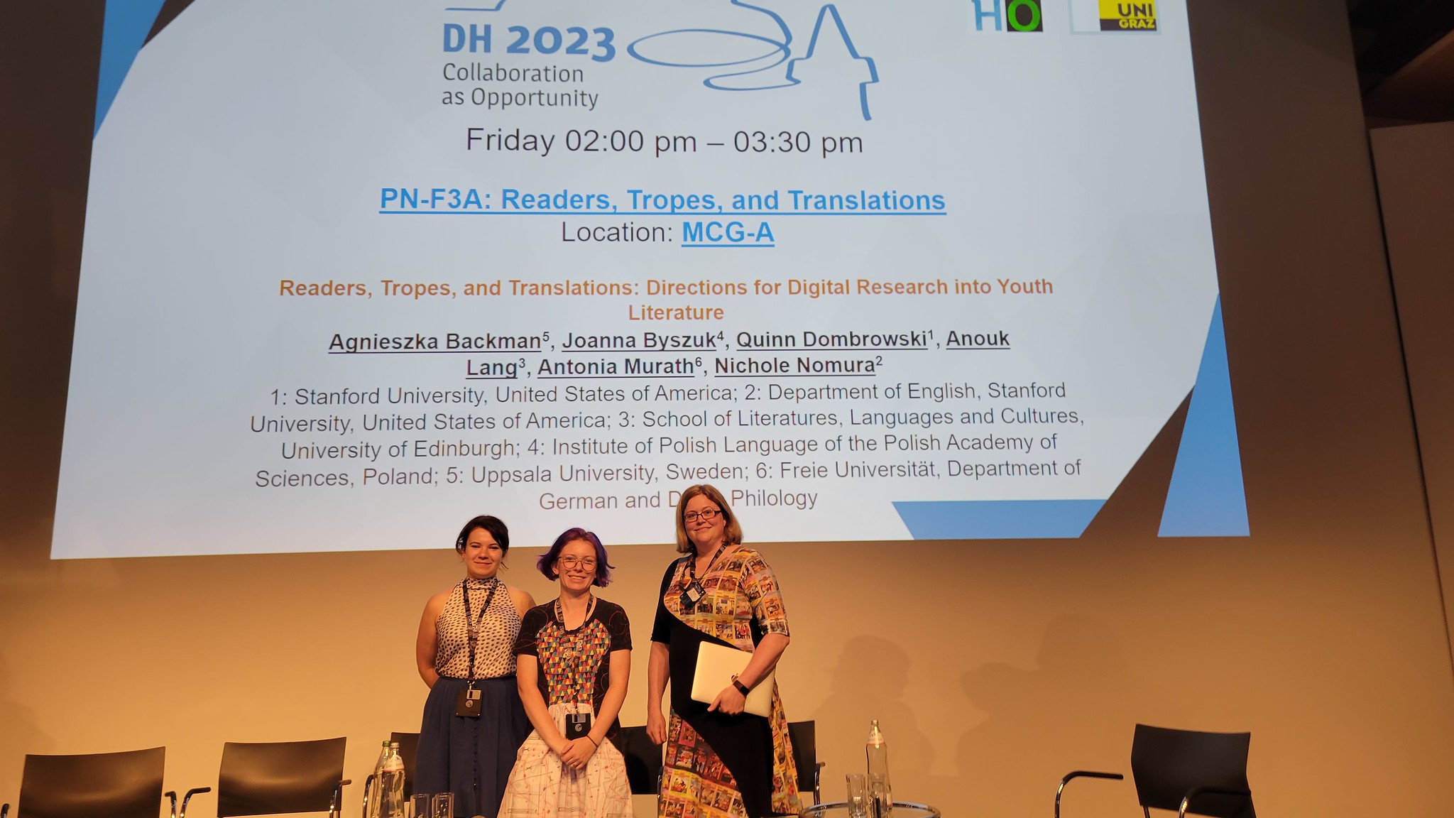 Joanna, Quinn, and Anouk at DH 2023 in front of their panel slide