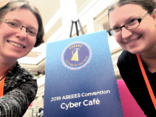 Picture of Quinn and Katia by the Cyber Café sign at the ASEEES Convention
