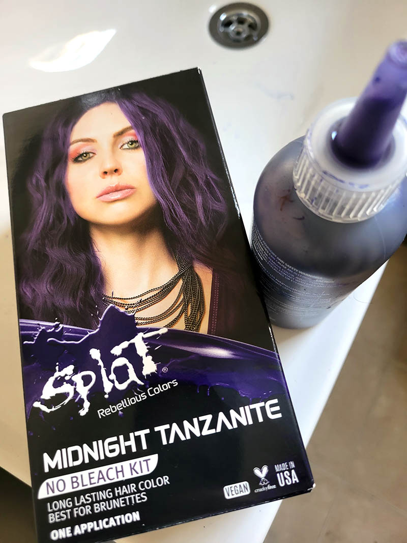 A box of purple hair dye and a used container of the dye.
