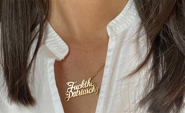 Maria wearing the 'fuck the patriarchy' necklace